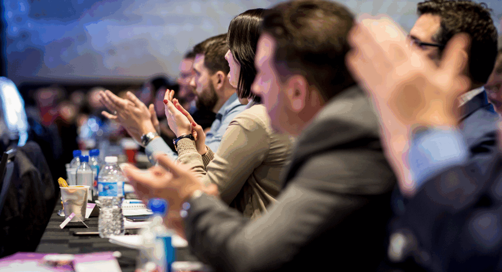 Audience clapping during a conference or seminar