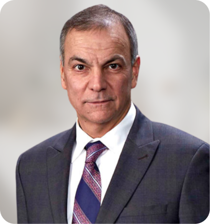 Portrait of a man in a dark suit and patterned tie