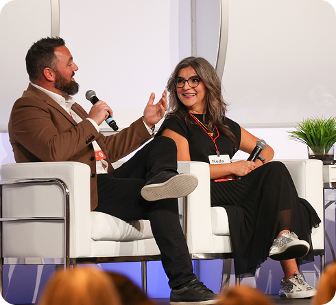 Two speakers sharing insights on stage at Masters Academy