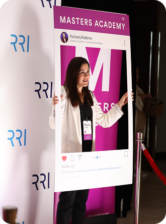 Woman posing with Masters Academy photo frame prop