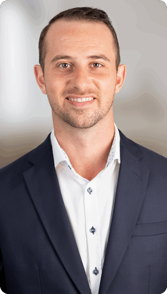 Man in navy suit smiling in professional headshot