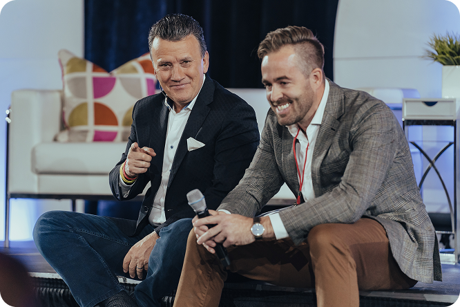 Richard Robbins and Darryl Watty speaking on stage