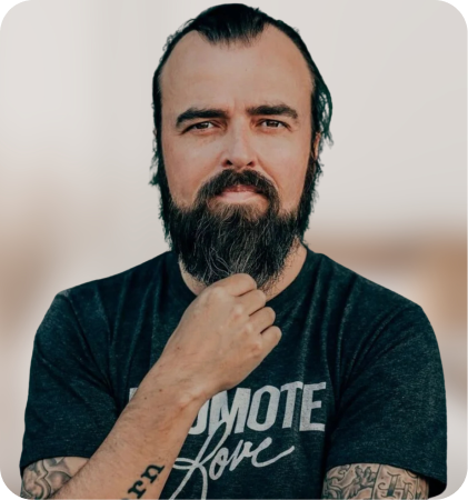 Portrait of a bearded man with tattoos wearing a black T-shirt