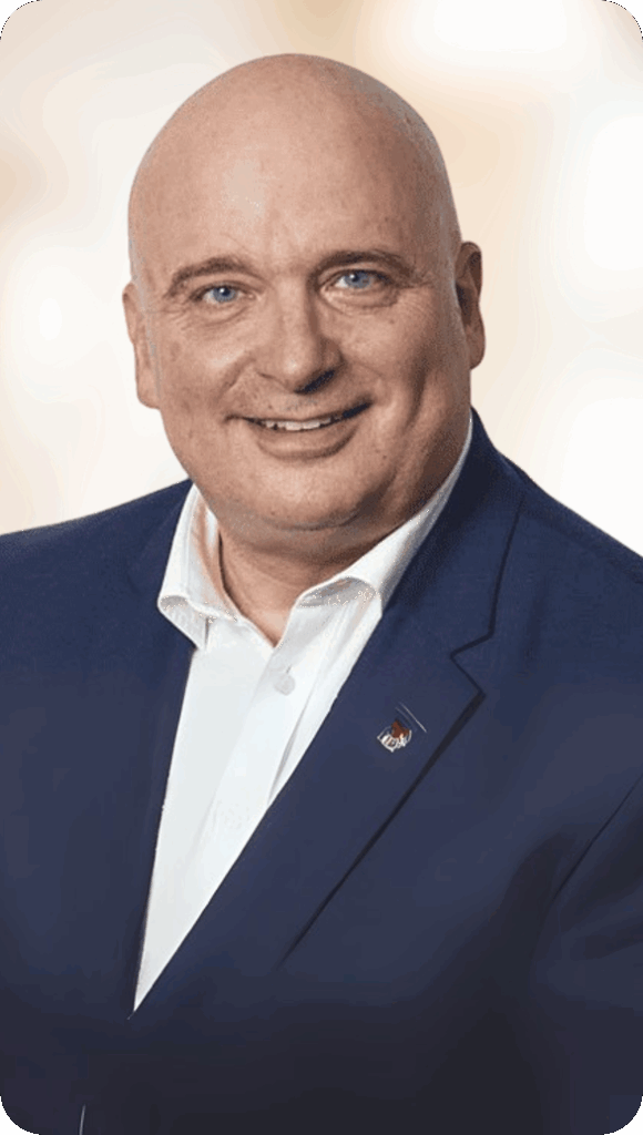 Portrait of a smiling bald man in a navy blue suit and white shirt