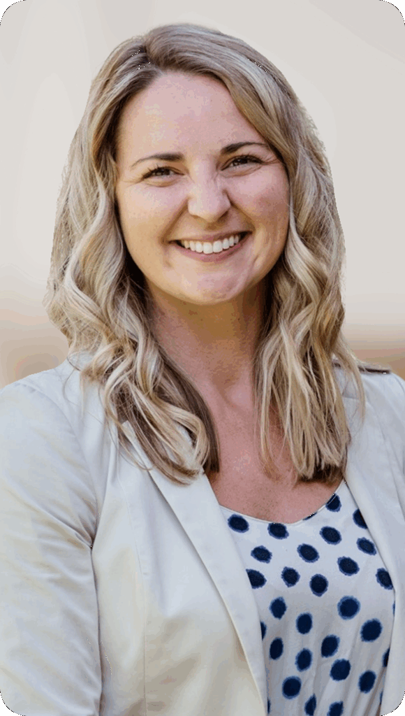 Portrait of a smiling woman with blonde hair wearing a cream blazer