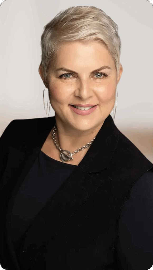 Portrait of a confident woman with short blonde hair and silver jewelry